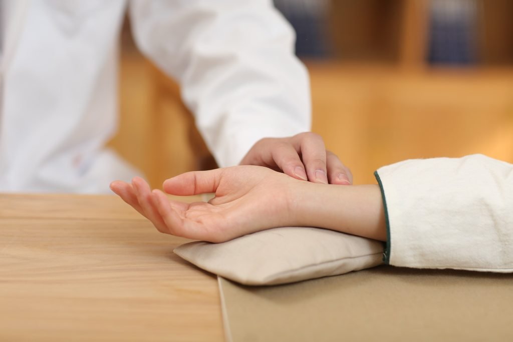 Traditional pulse diagnosis for personalized treatment.